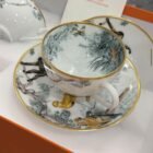 Hermès Carnets d'Equateur breakfast cup and saucer, porcelain with gold rim and jungle print