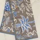 Hermès Isola di Primavera double face silk scarf 90, folded to show both sides and blue rolled hem