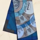 Hermès Jeu des Omnibus Remix silk scarf 90, folded with navy rolled hem