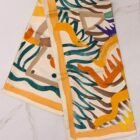 Hermès Le Cavalier à la Trompette silk scarf 90, folded with apricot border