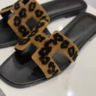 Hermès Oran sandal in leopard, close up of the H strap with raised black spots