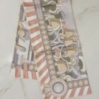 Hermès Pony Pit Stop double face silk scarf 90, folded with striped border